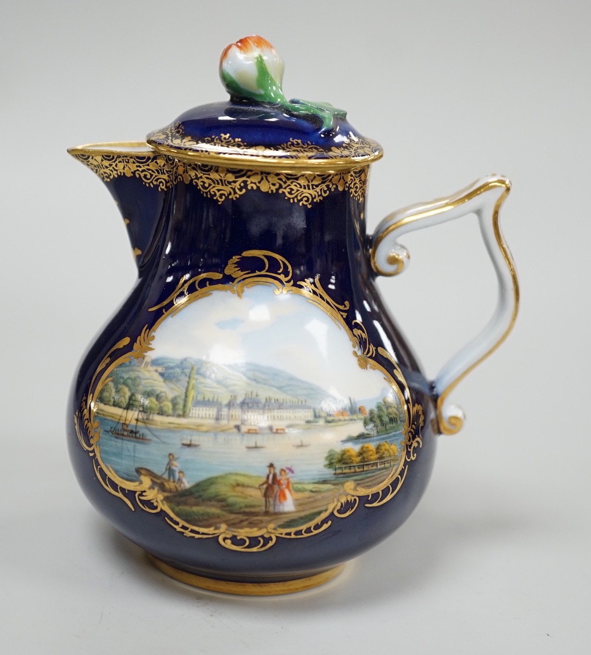 A small 19th century Meissen cobalt blue ground jug and cover, 9.5cm tall